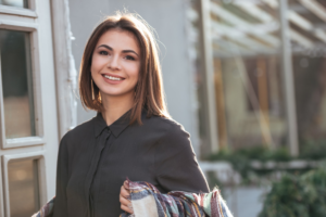 graphicstock-portrait-of-young-cheerful-lady-look-at-camera-walking-near-cafe-outdoors_rOlKY20Ine-smaller